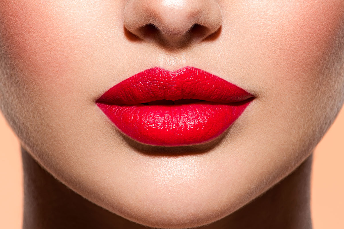 woman-lips-with-a-red-lipstick-on-lips-closeup-fem-J6J2YUL